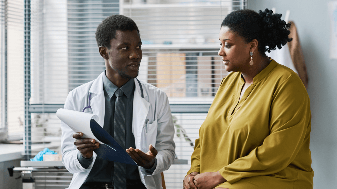 Doctor reviewing medical records with a patient