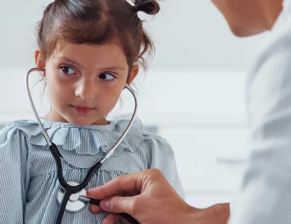 Child listening to her heart beat through a stethoscope