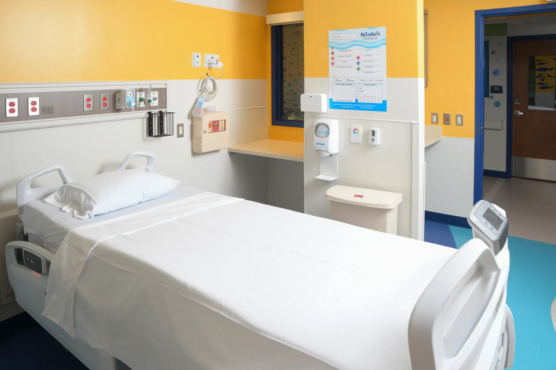 Colorful hospital room with yellow walls and a child sized hospital bed