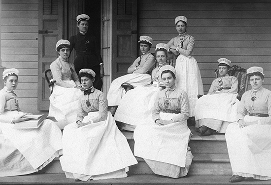 Nurses sitting outside building