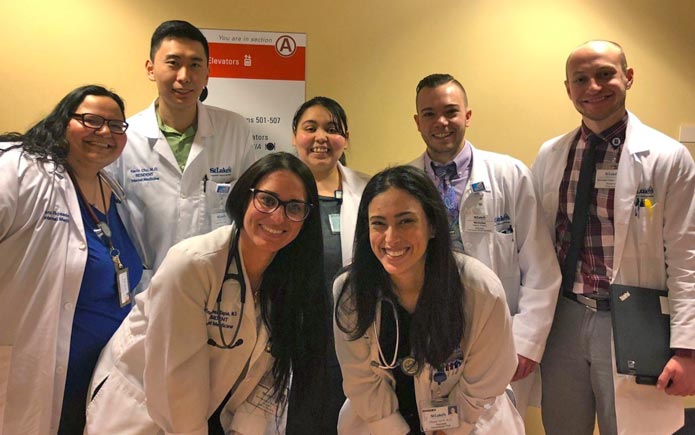 Dr. Rosado and her team of interns, seniors and pharmacists  take time to smile after morning floor rounds. 