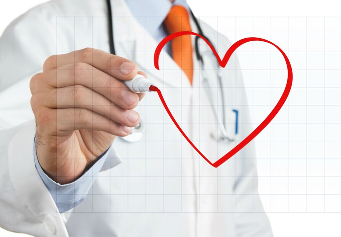 doctor drawing heart on smart board