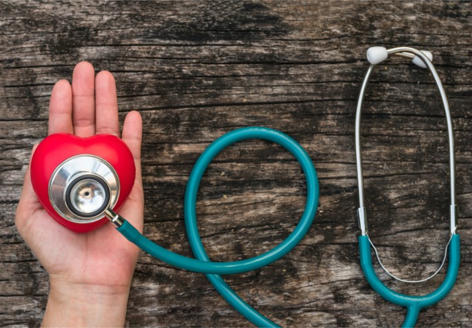 hand holding heart and doctor tool