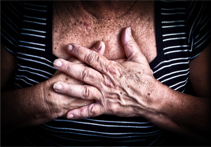 woman holding her chest