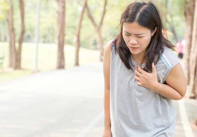 woman grabbing her chest having heart attack
