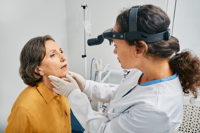 ENT doctor examines her patient’s larynx