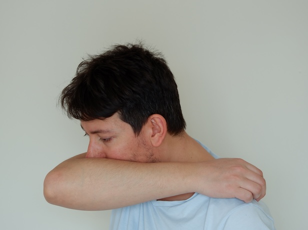 Man concealing his chronic cough