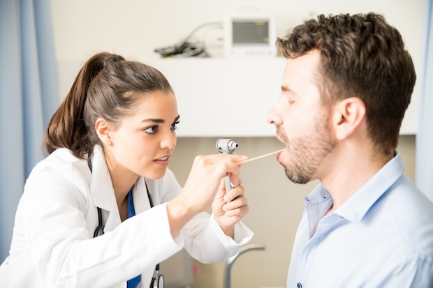 Provider examines her patient’s vocal cords