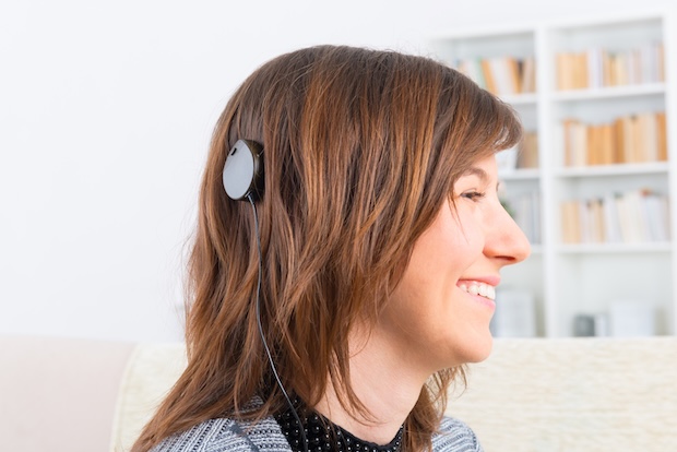 Woman displays her cochlear implant