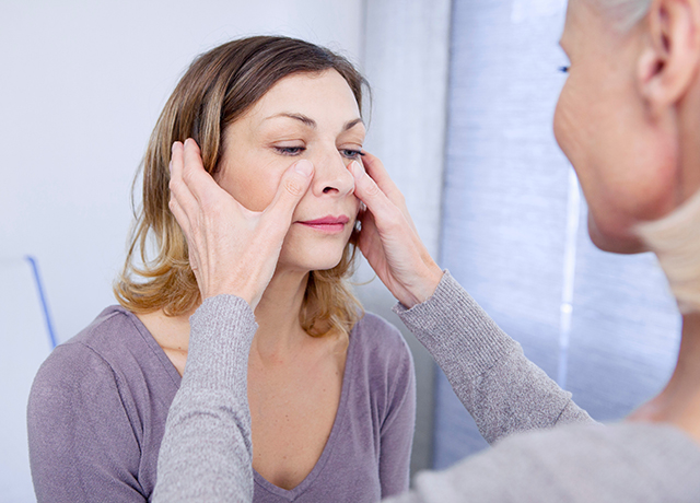 Provider examines a patient’s sinuses