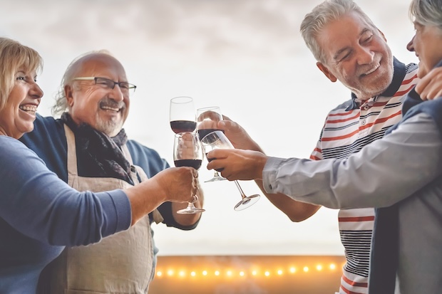 Four individuals enjoying a glass of wine together