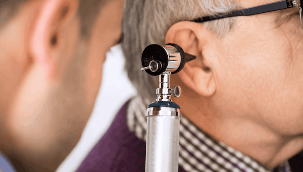 Male patient getting his ear examined