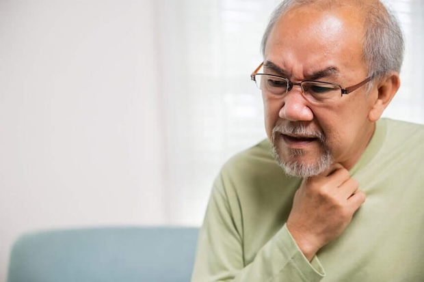 Man holding his neck due to discomfort