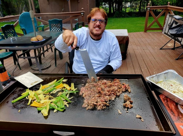 Ronnie Tutko cooking on a grill