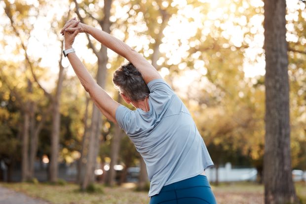 Individual stretching out their spine and back before going out for a run