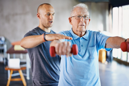 Medical Professional assisting patient with weights