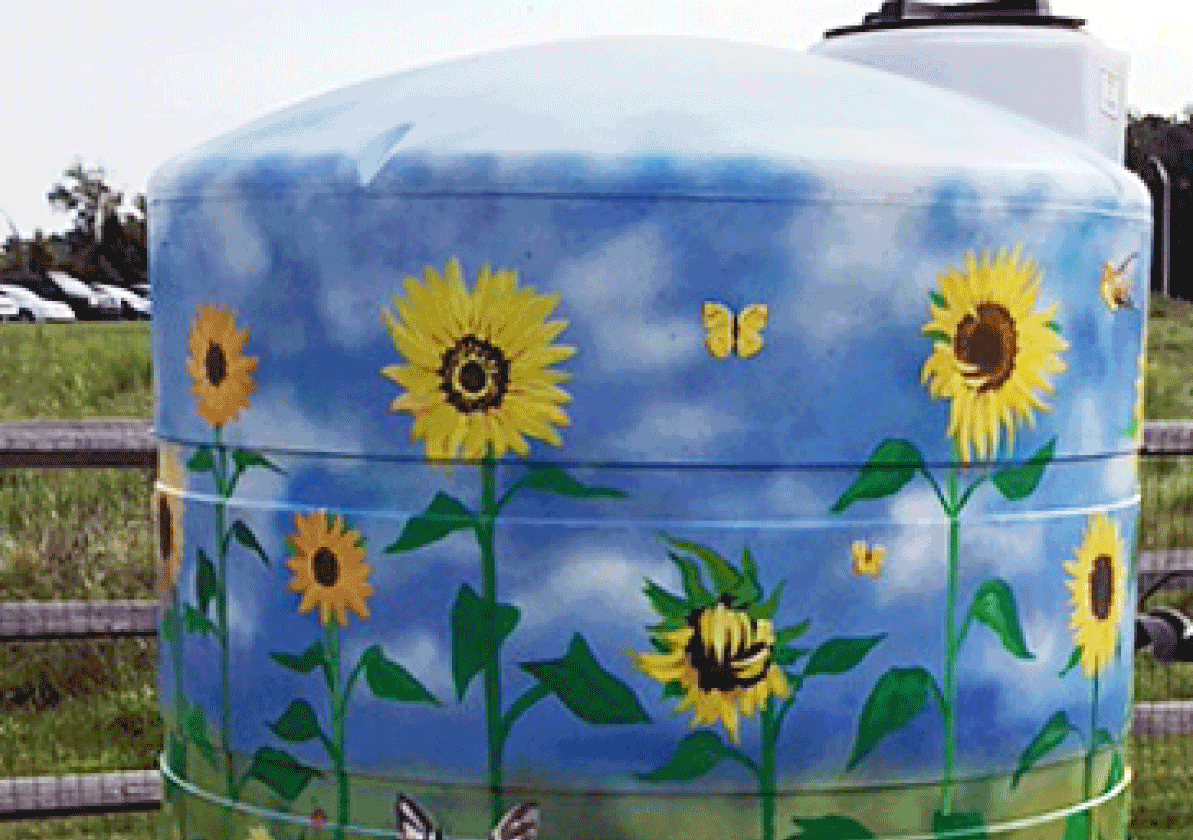Painted sunflower mural in a field