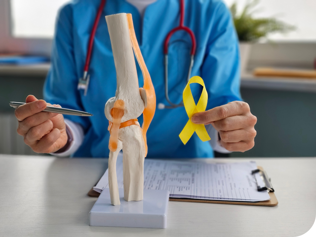 Medical Professional holding a yellow cancer ribbon