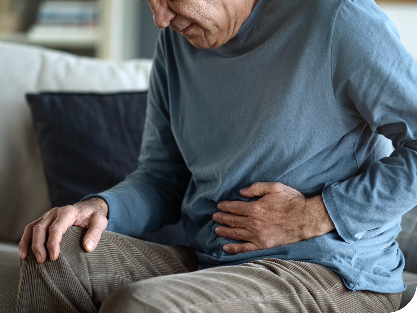 Elderly individual holding his stomach