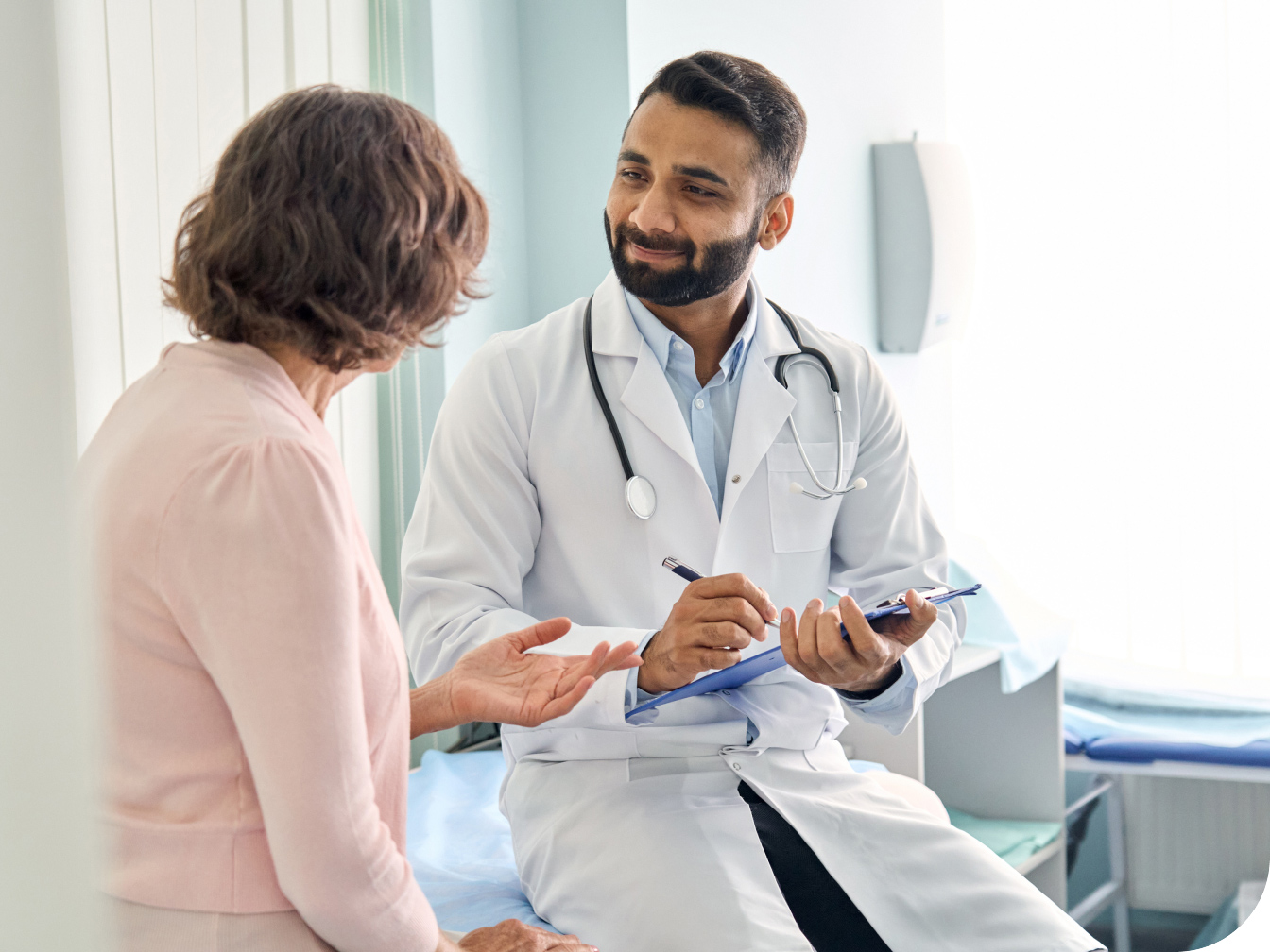 Medical Professional talking with a patient in an exam room
