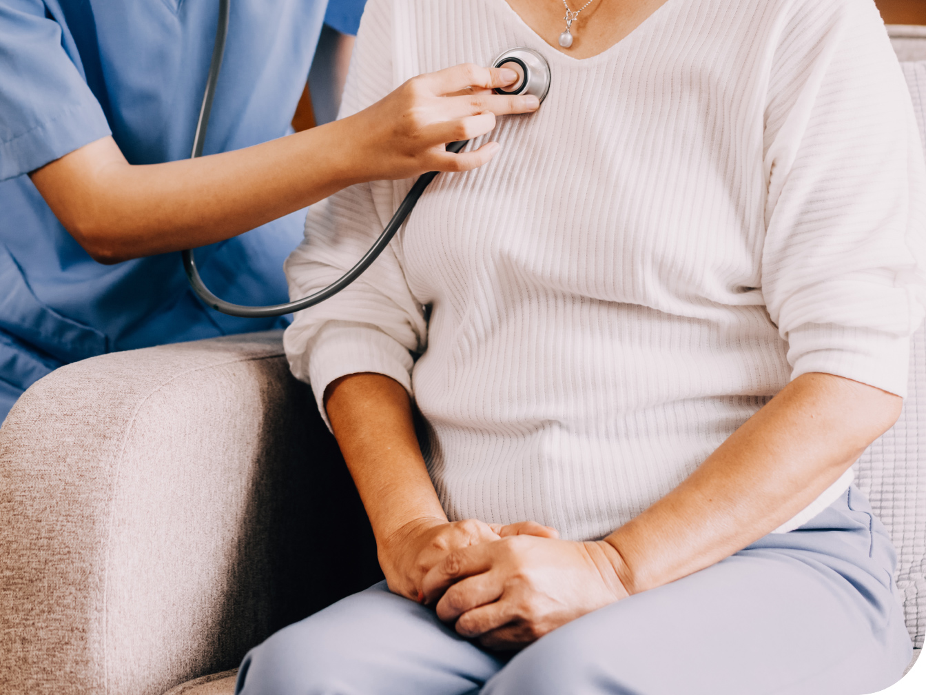Medical Professional listening to a patient's chest with a stethoscope