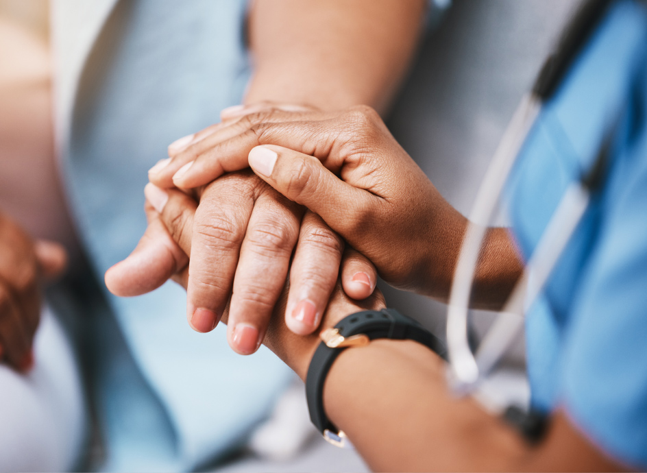 Close up of a Medical Professional holding a patient's hand
