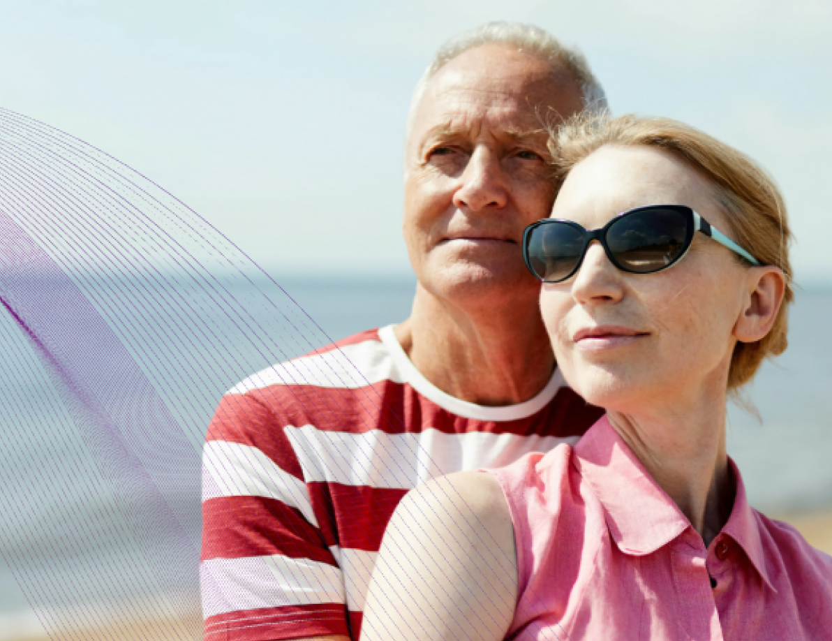 Older couple posing on a beach