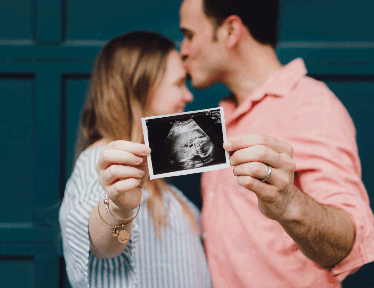 Couple holding ultrasound photo