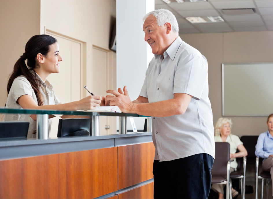 Office admin assisting patient with appointment
