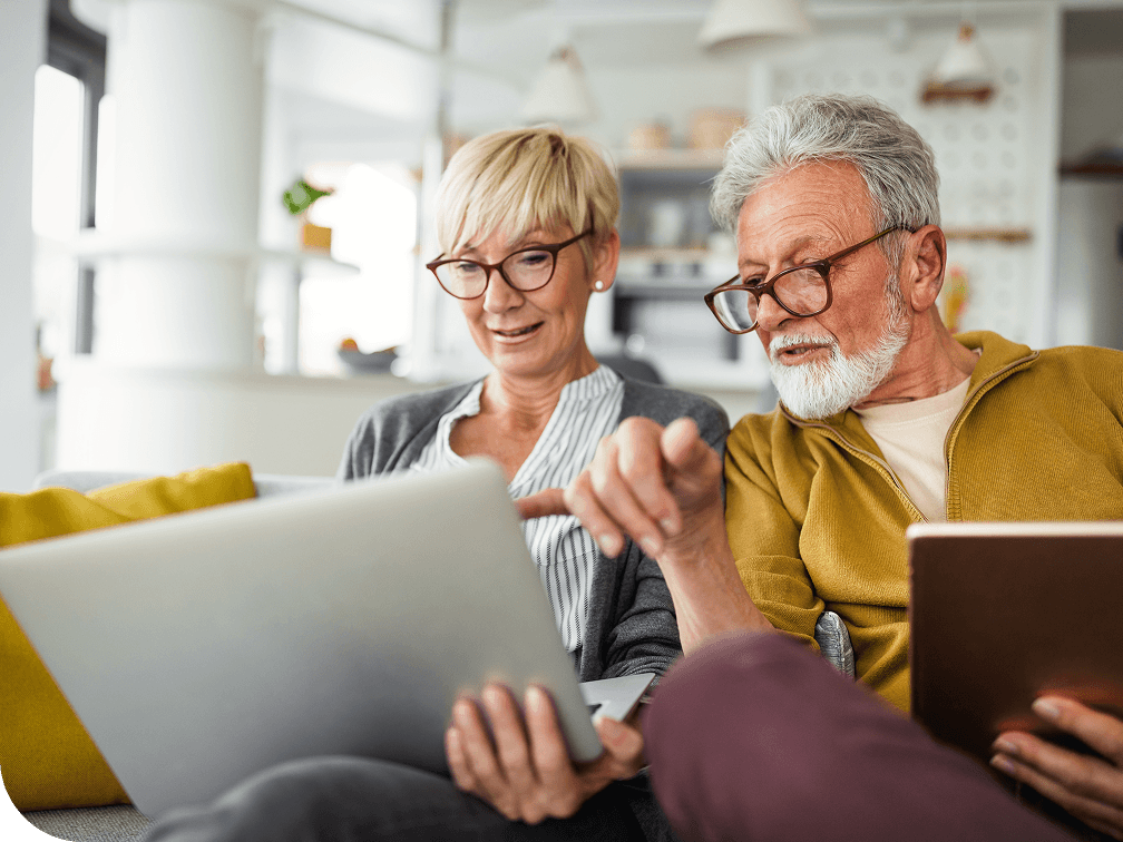 Elderly couple working on a laptop together