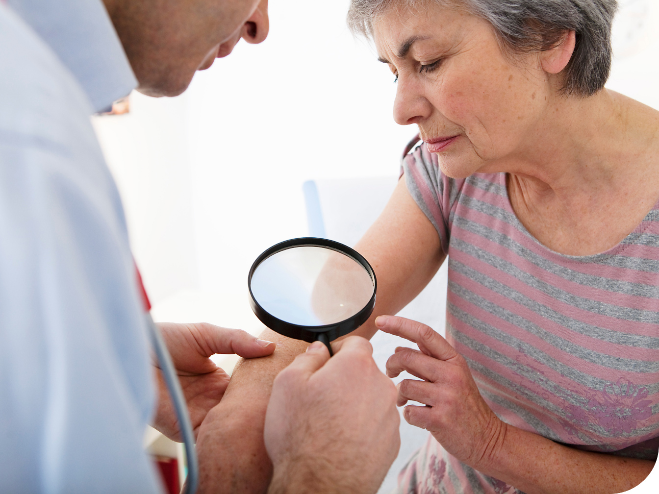Medical professional looking at a patient's arm
