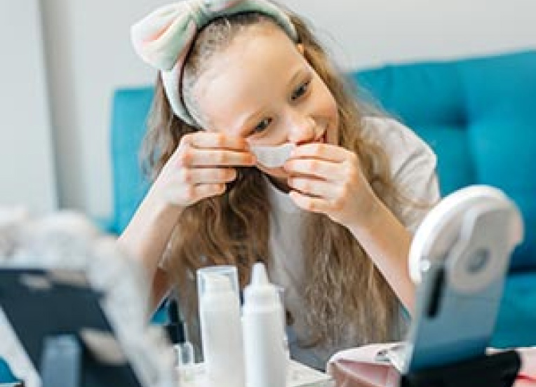 Pre-teen using under eye strips