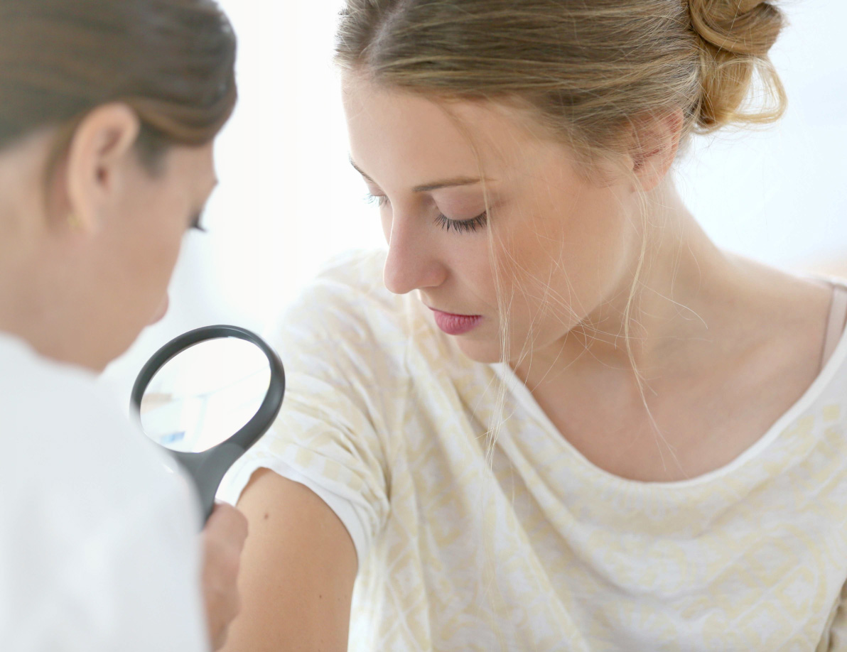 Medical Professional looking at patient's skin