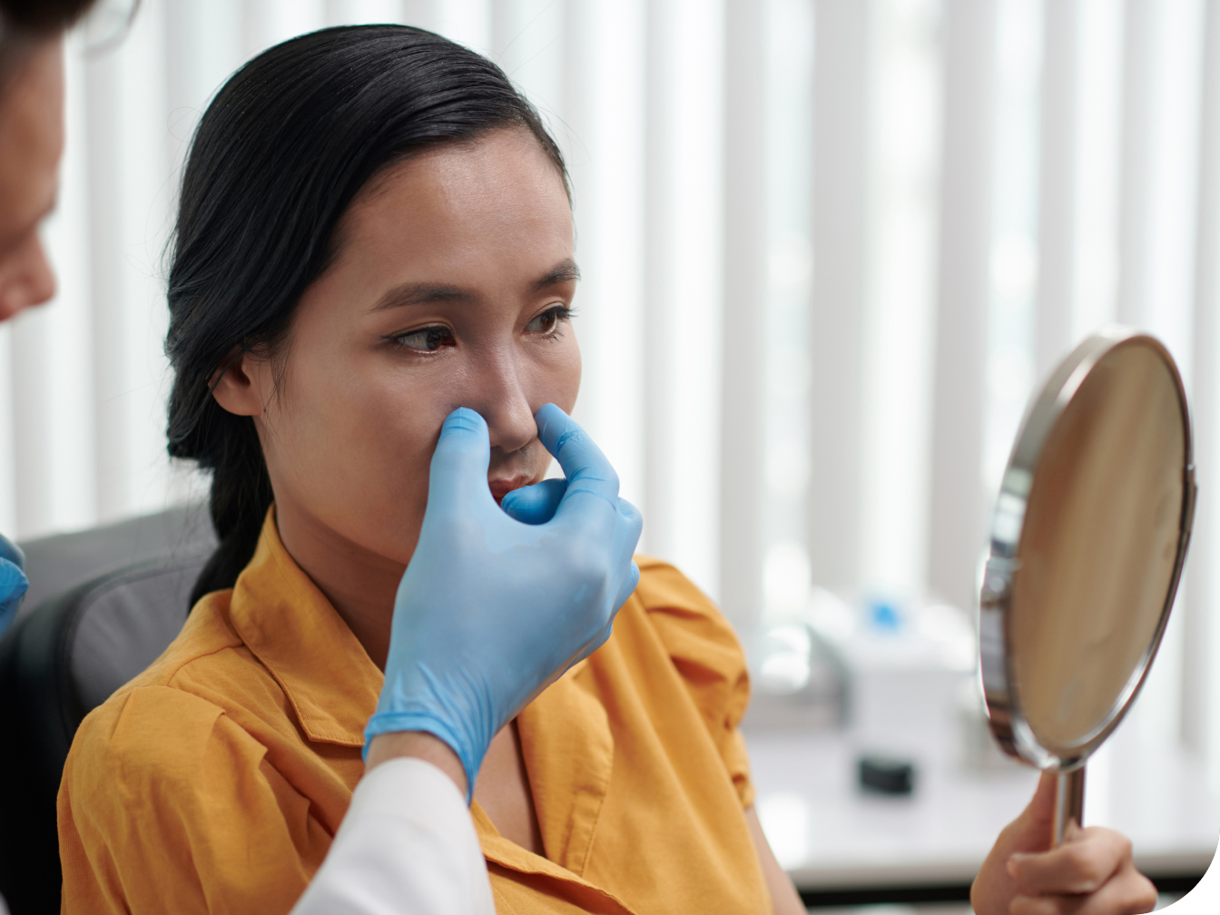 Young woman having her nose evaluated by a medical professional