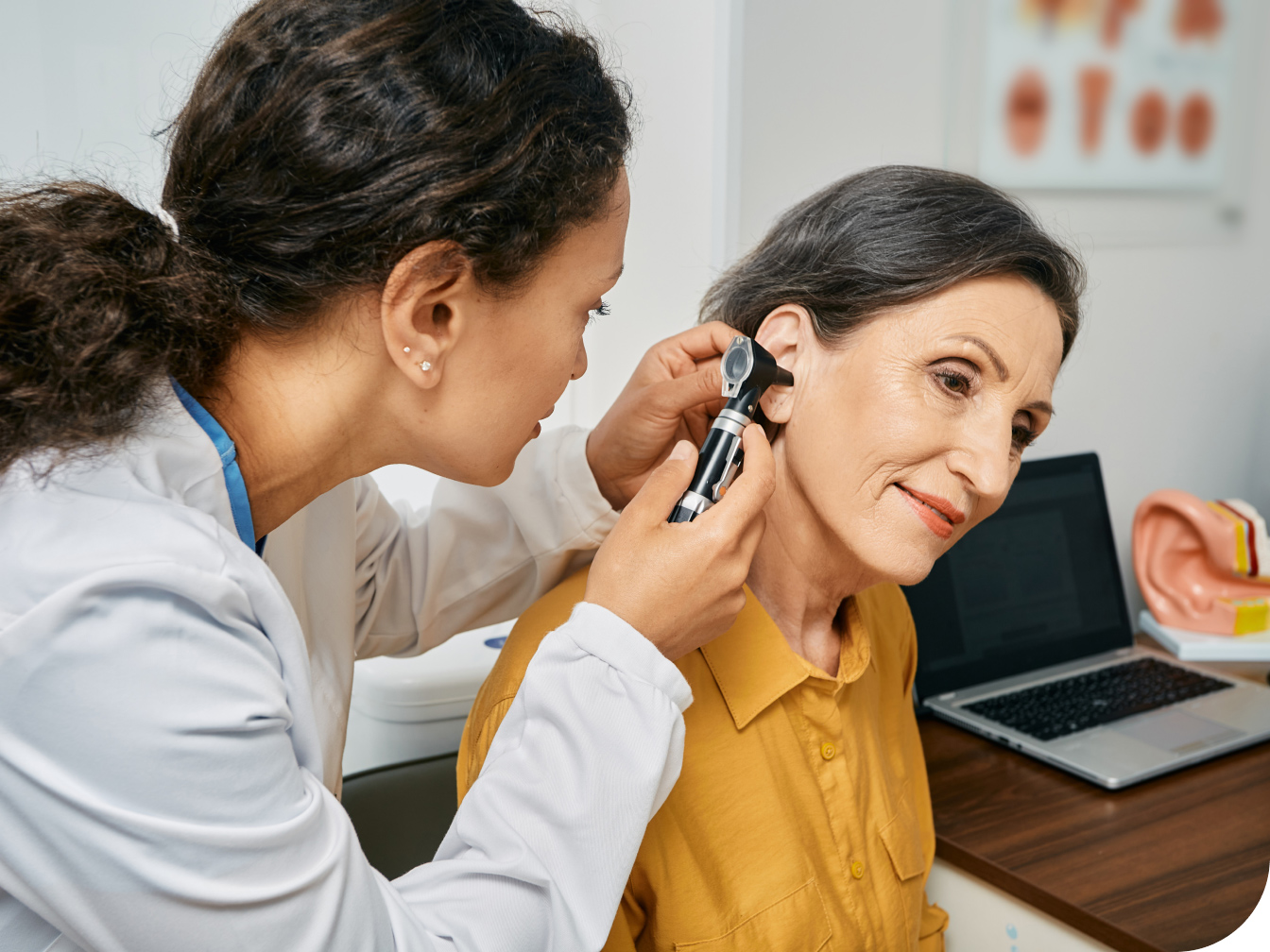 Medical professional looking into a patient's ear