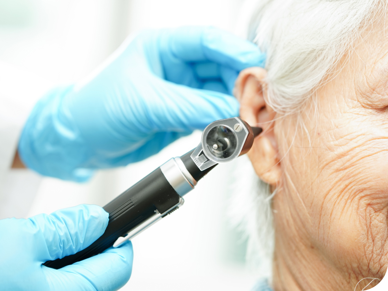 Medical professional looking into patient's ear
