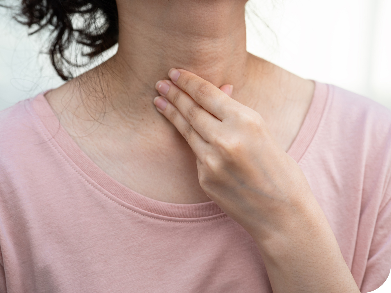 Individual holding her throat