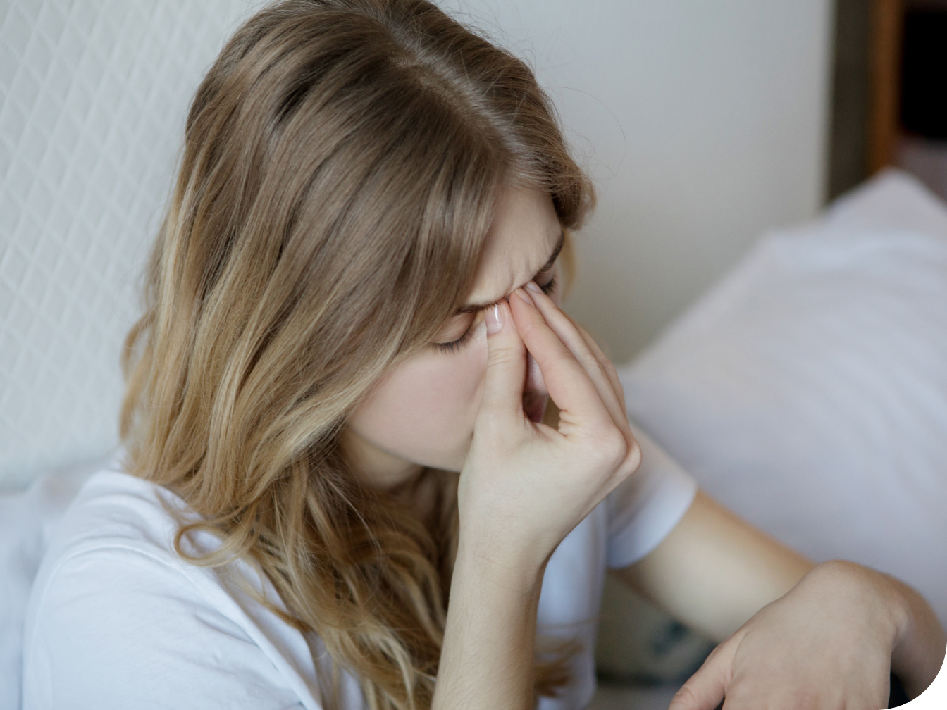 Young woman holding her head in pain