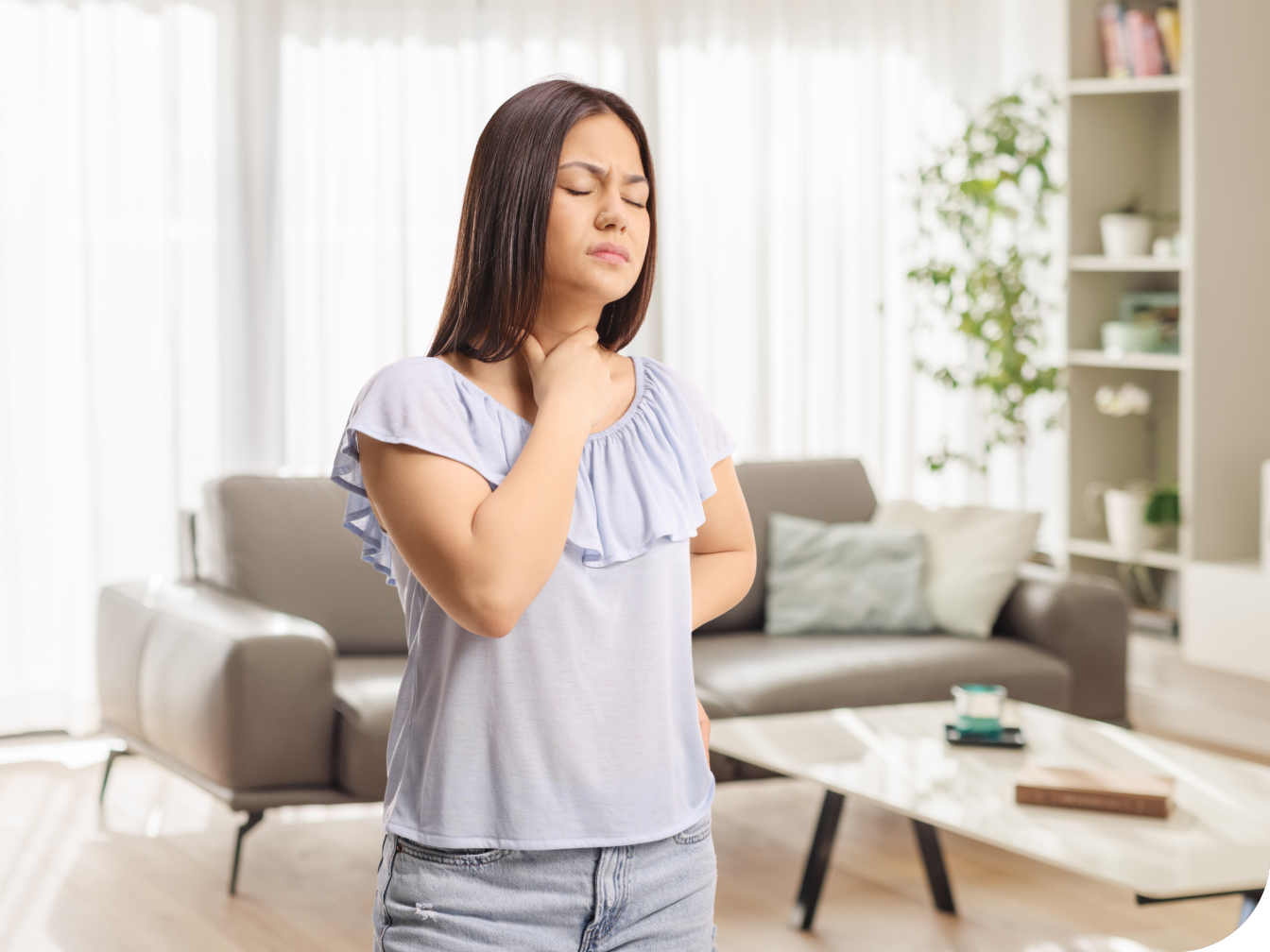 Young woman holding throat