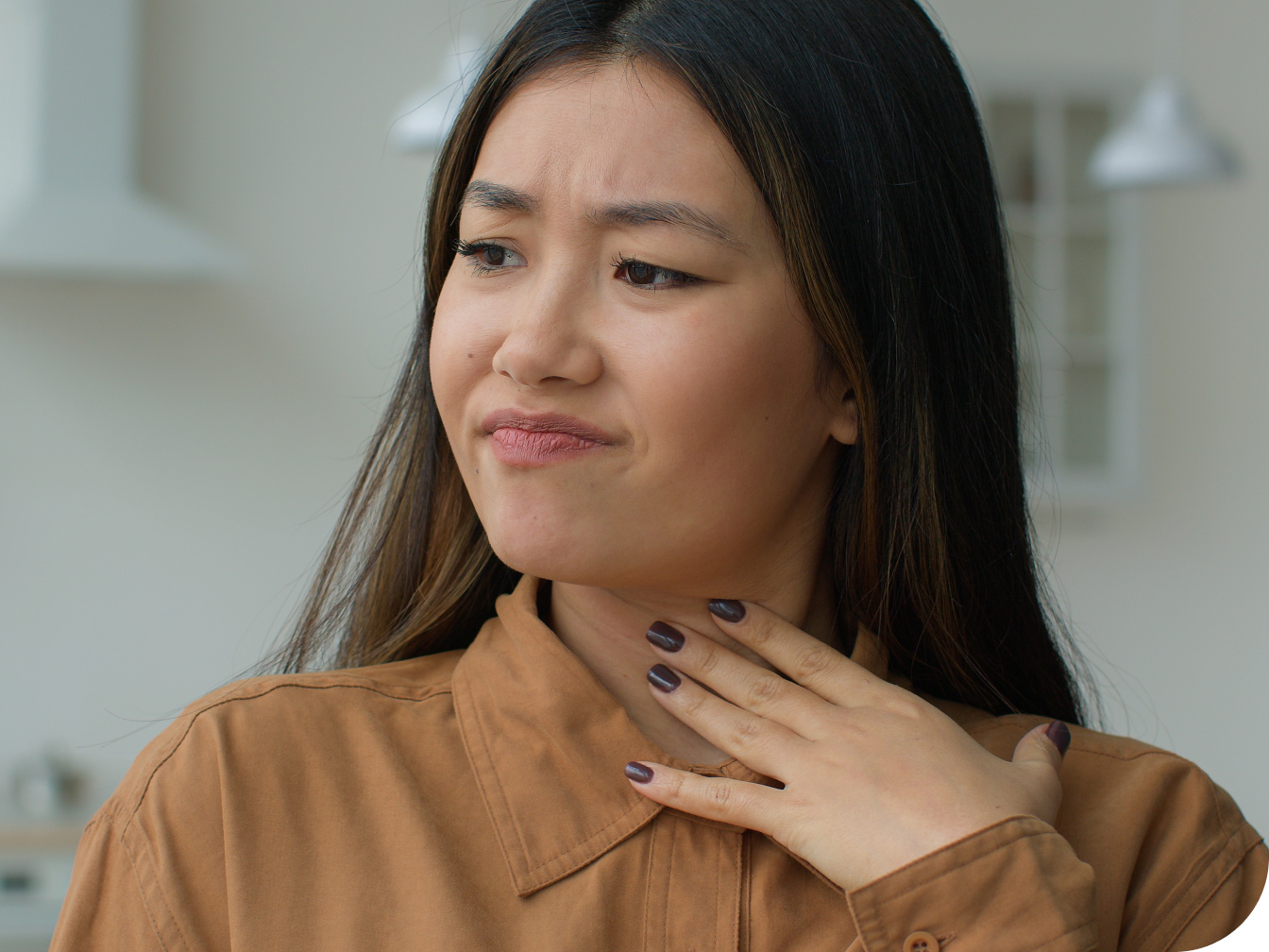 Women holding her throat in pain