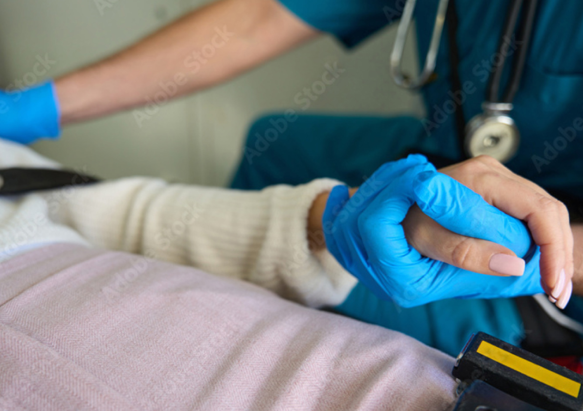 Emergency Services Professional holding a patient's hand