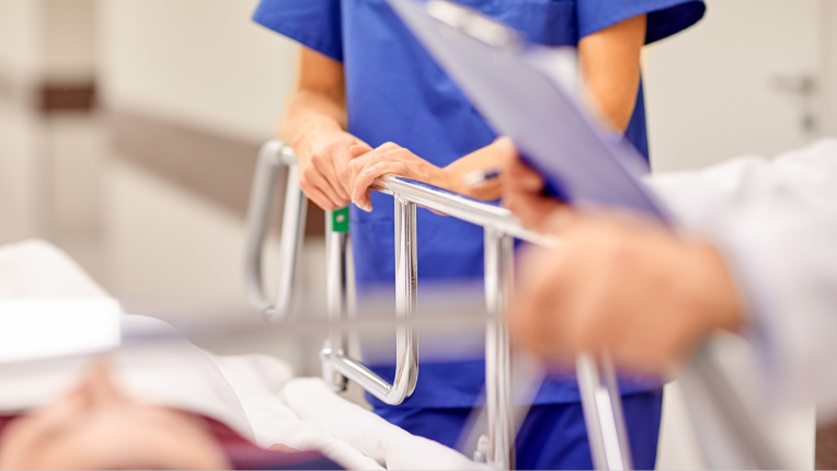 Medical Professionals around a patient's hospital bed
