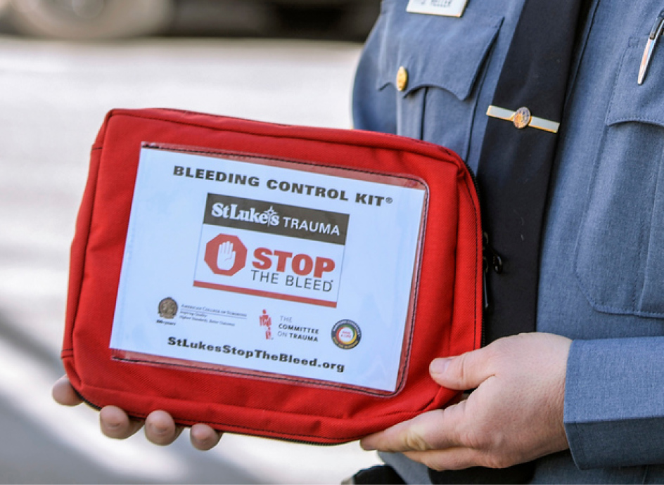 Emergency services professional holding a tablet with Stop the Bleed information