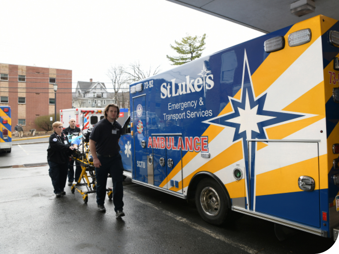 Emergency personnel next to an ambulance