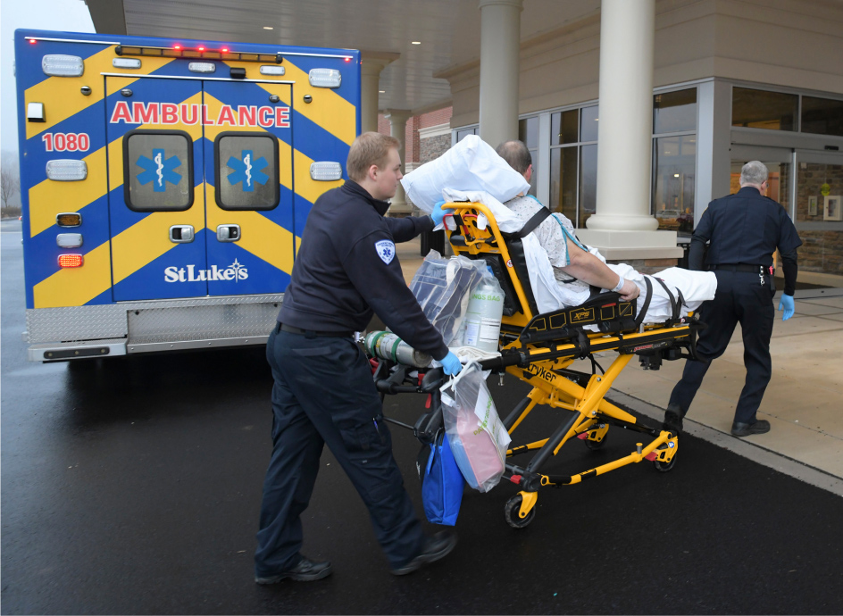 Emergency personnel dropping a patient off at a hospital emergency room