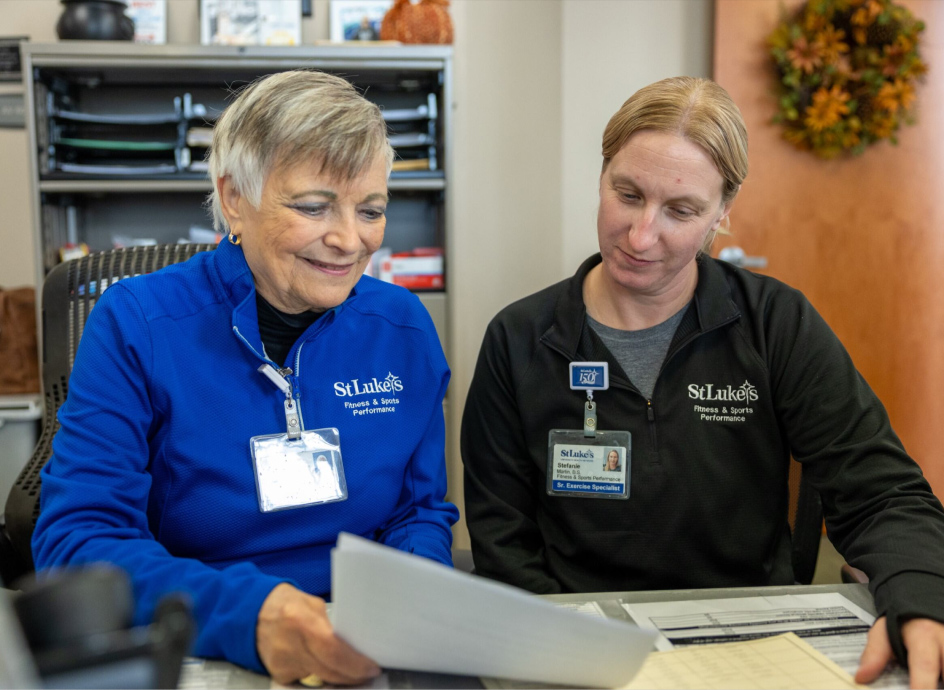 Fitness team going over paperwork at a desk