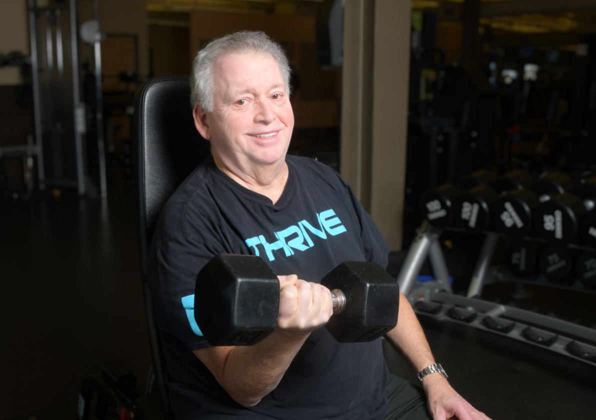 Gym member lifting a dumbbell 