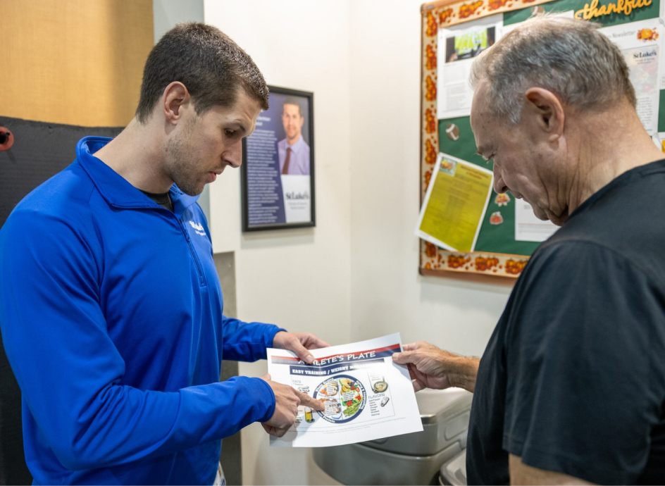 Gym instructor going over nutritional information with a member