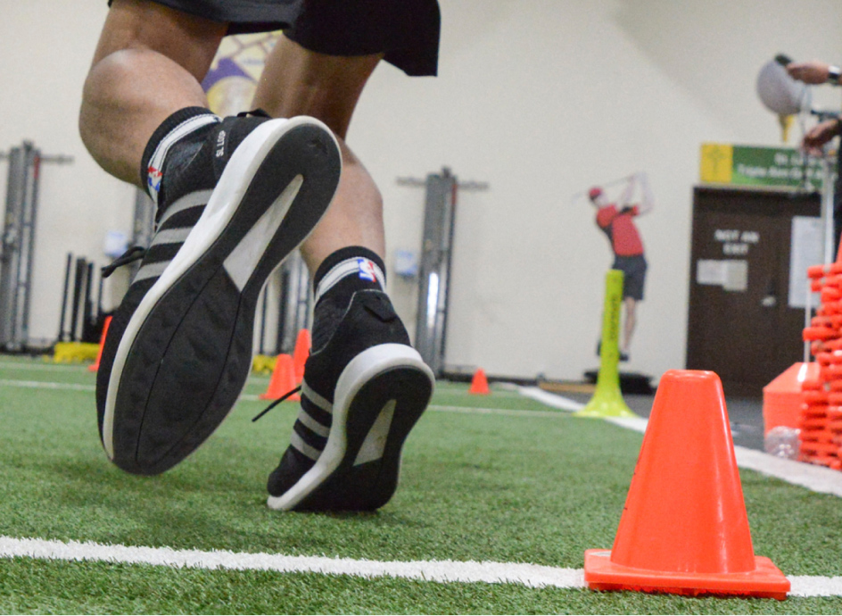 Athlete running on an indoor turf field