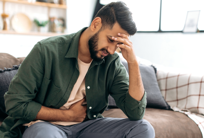 Individual holding stomach in pain